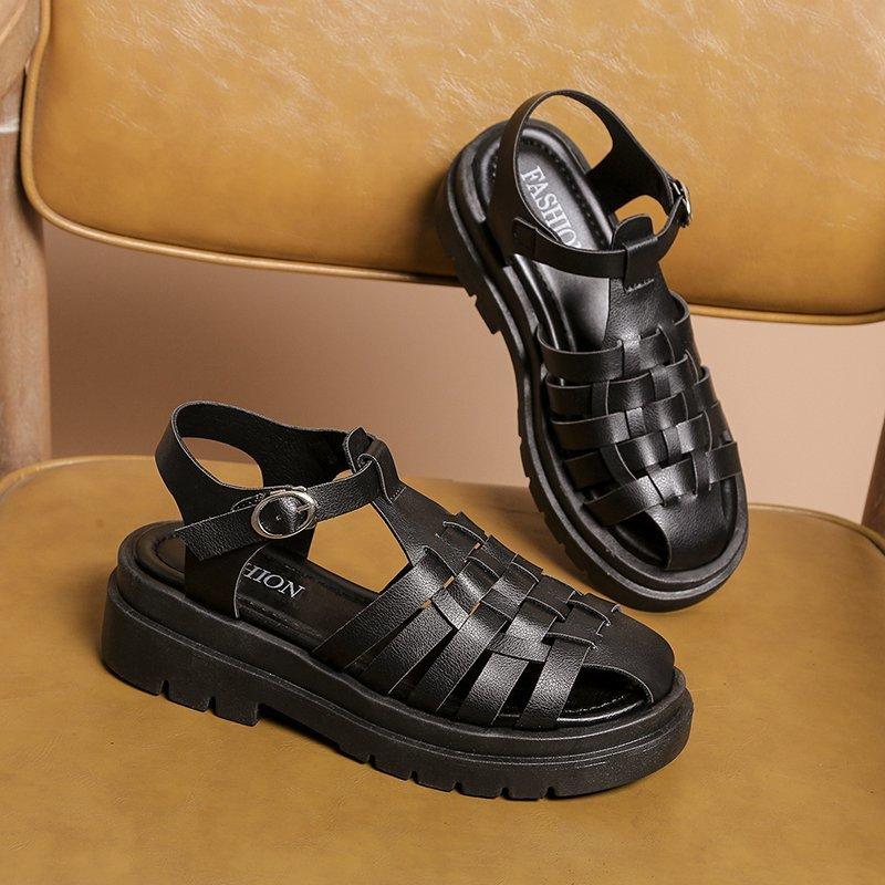 Modern black leather platform sandals with buckle detail and ankle strap