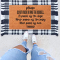 A natural brown coir doormat with 'Please Do Not Knock Or Ring The Doorbell' text on a porch.