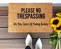 Funny doormat with black text on brown background stating 'Please No Trespassing We Are Tired Of Hiding Bodies'.