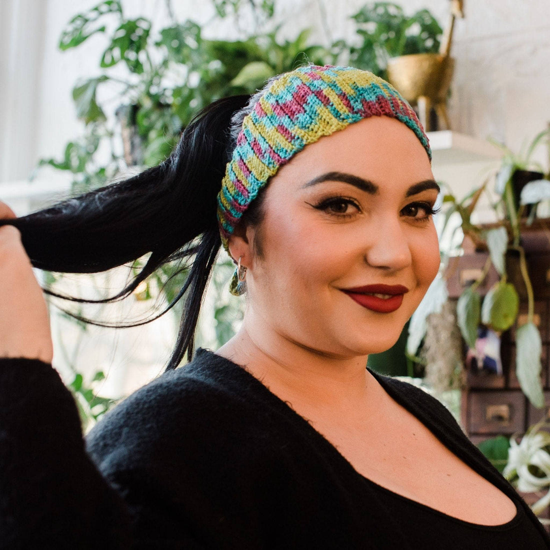 Close up of a handmade Plume Headband showing detailed texture from knit and crochet pattern.