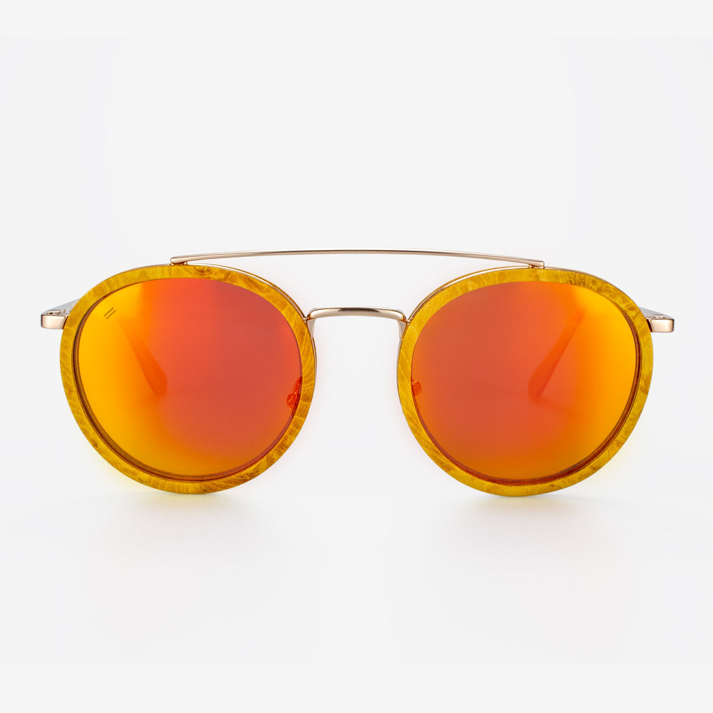 Ponce sunglasses featuring burl wood frames and a gold curved brow bar.