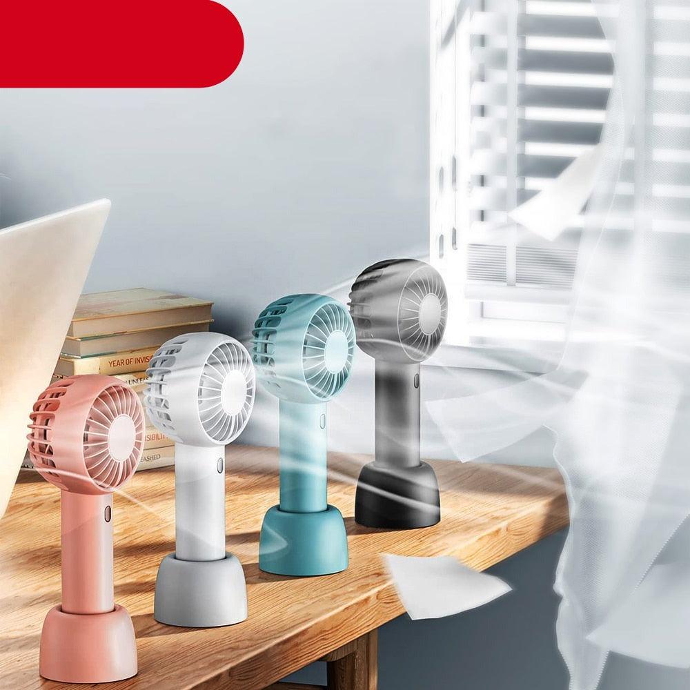 Small handheld USB fan with a desktop base in pink, white, teal, or black.