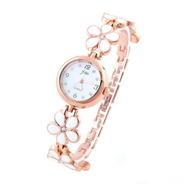 Women's quartz bracelet watch in rose gold featuring flower-shaped links with white petals and a round white watch face.