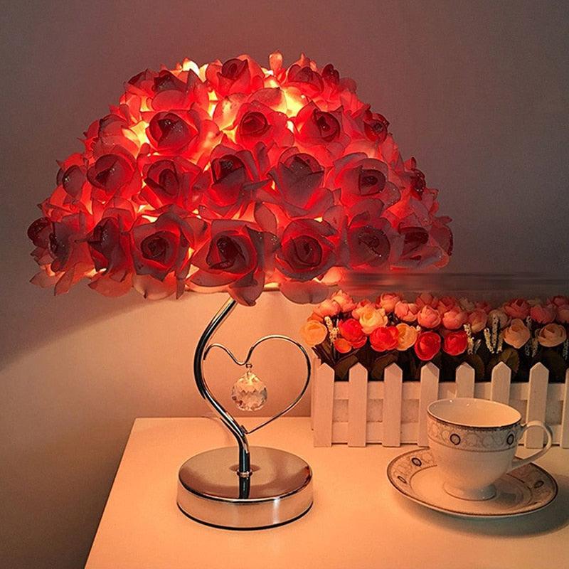 Decorative pink and cream rose flower table lamp with silver base.