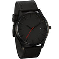 Elegant black men's watch with quilted leather strap and date display on a clean background