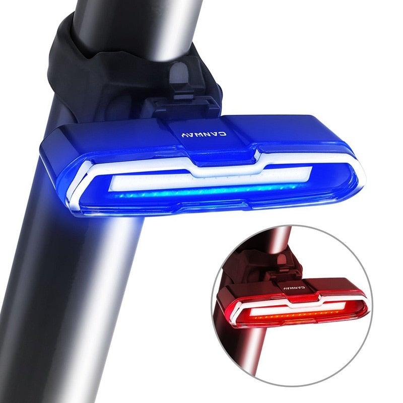 Ultra bright USB rechargeable LED bike tail light with red and blue light modes attached to a bicycle