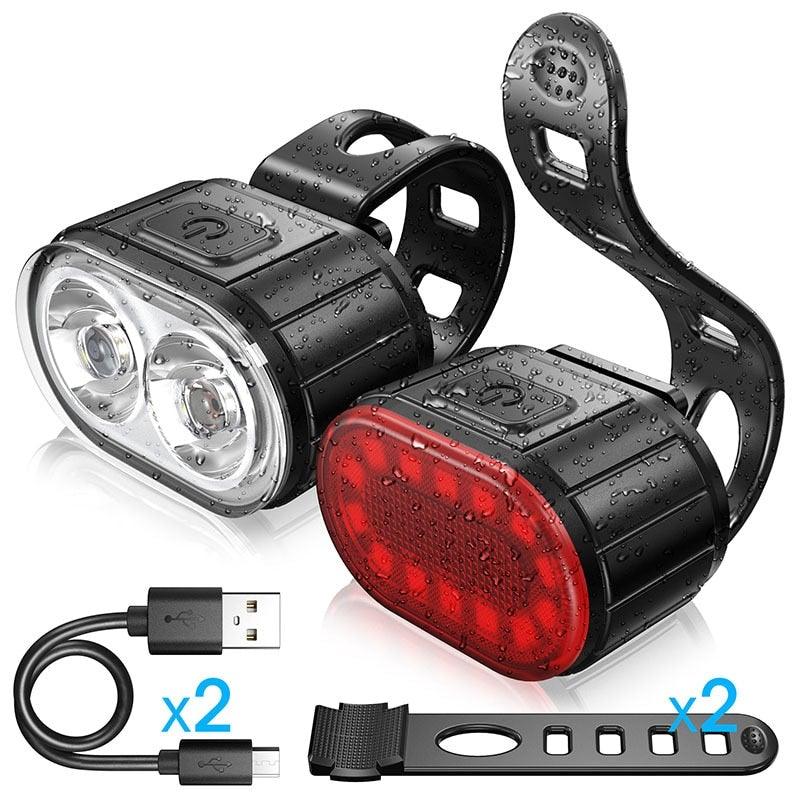 Stevvex 350-lumen LED bicycle headlight and taillight combo set in black, showing USB charging port and mounting features.