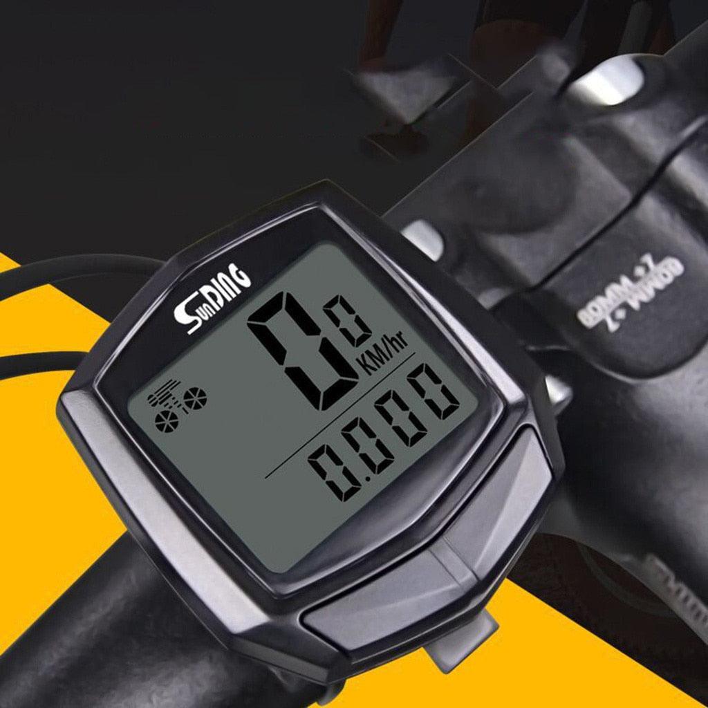 Wired bike computer with large LCD display screen mounted on a bicycle handlebar