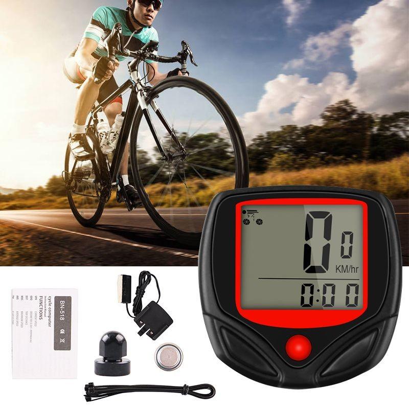 Close up of a black and red digital bike speedometer mounted on a bicycle handlebar.
