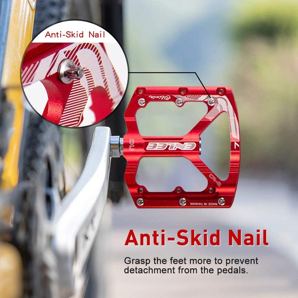 Close up of black CNC aluminum alloy flat bicycle pedals with hexagon grip bolts