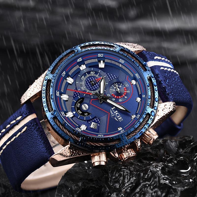 Men's sports watch featuring a deep navy blue dial, rose-gold case, and black leather strap with buckle closure