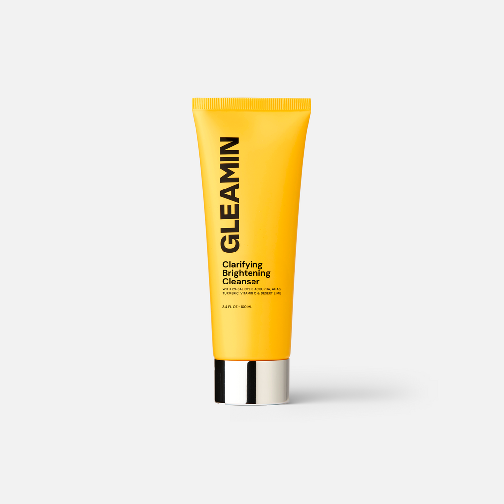 Yellow tube of Gleamin Clarifying Brightening Cleanser with key ingredients listed including 2% Salicylic Acid, Vitamin C, and Turmeric.