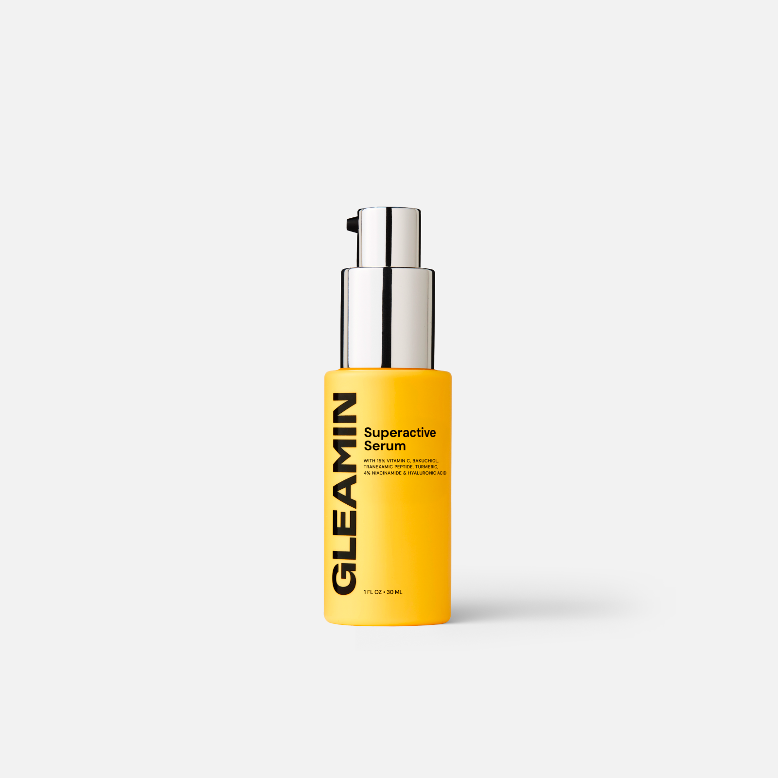 Bottle of Gleamin Superactive Serum in a yellow container with silver pump, featuring key ingredients on the label.