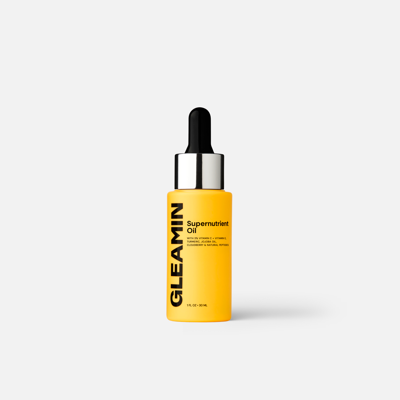 A 30ml bottle of Gleamin Supernutrient Oil featuring Vitamin C, Jojoba, and Turmeric on a clean background.