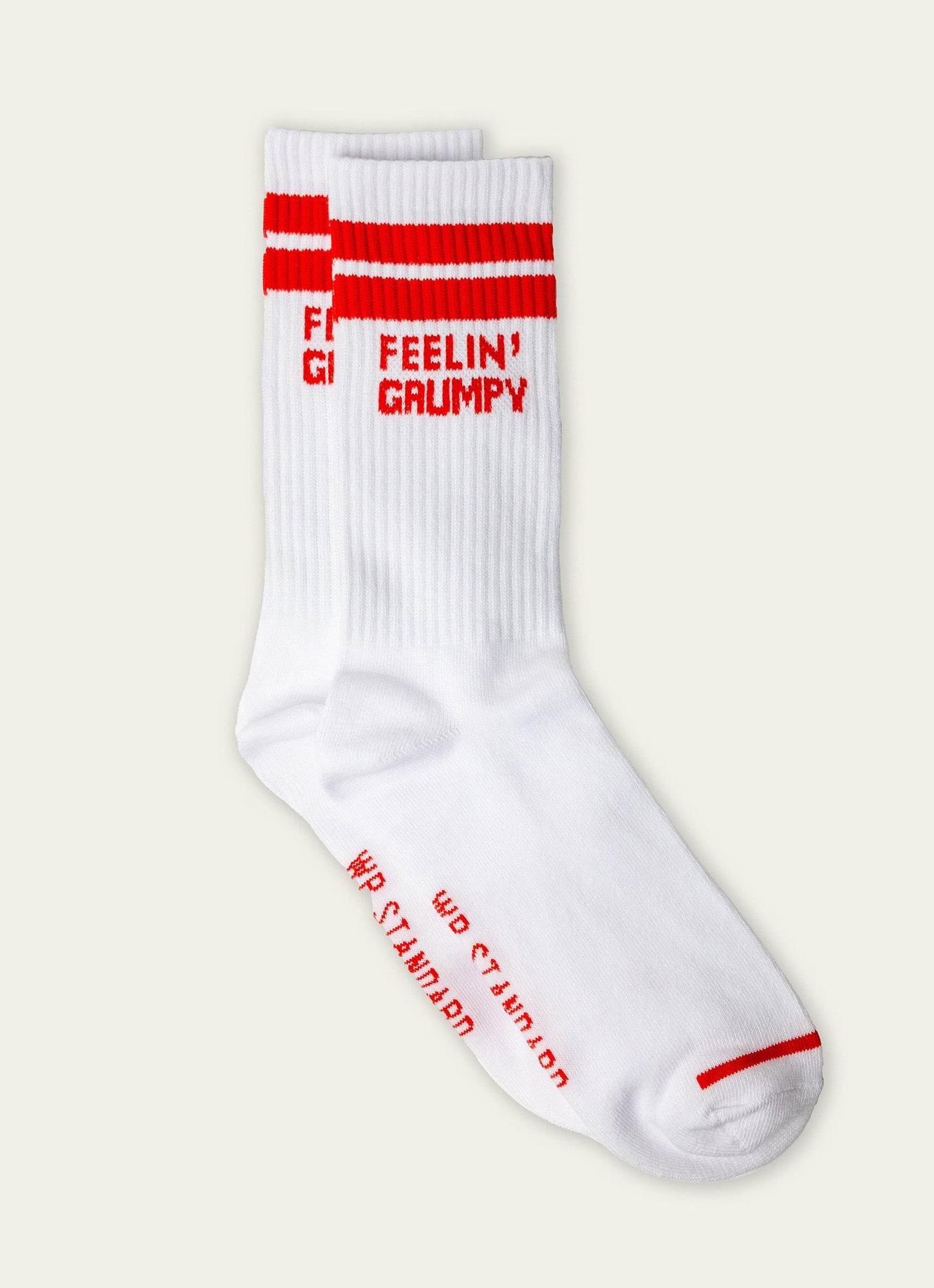 White sock with red text and accents on a light gray background