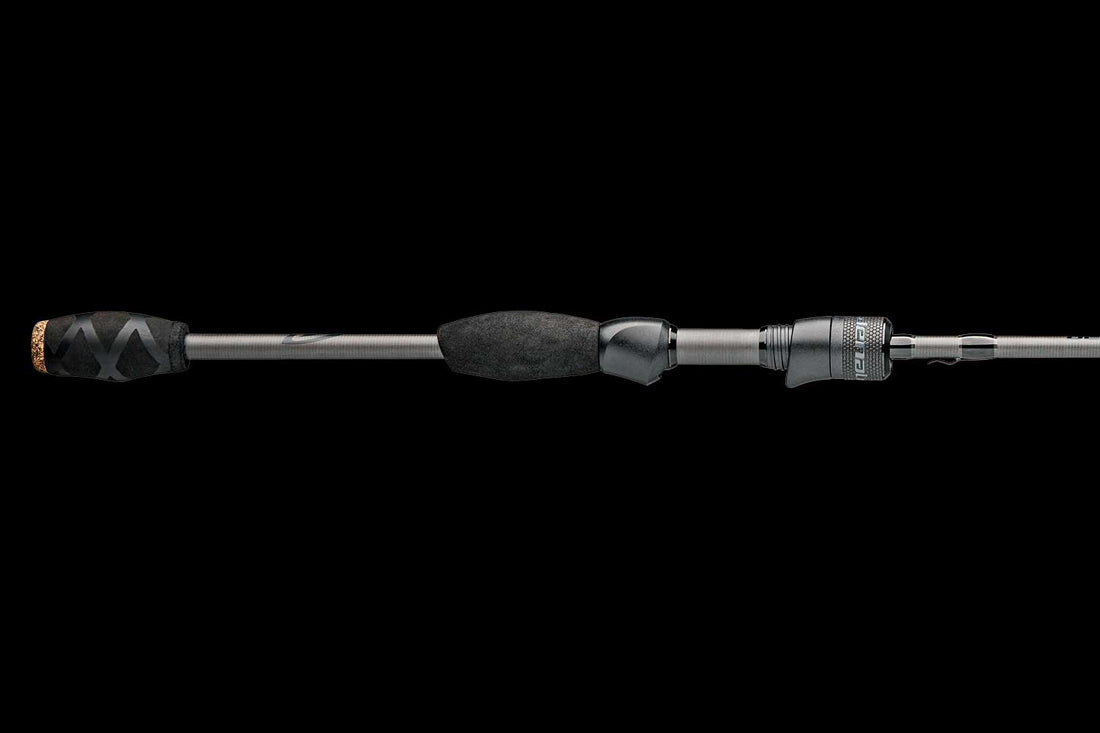 Close up of the Denali Pryme Onyx Series fishing rod handle with black foam grips and graphite rod blank.