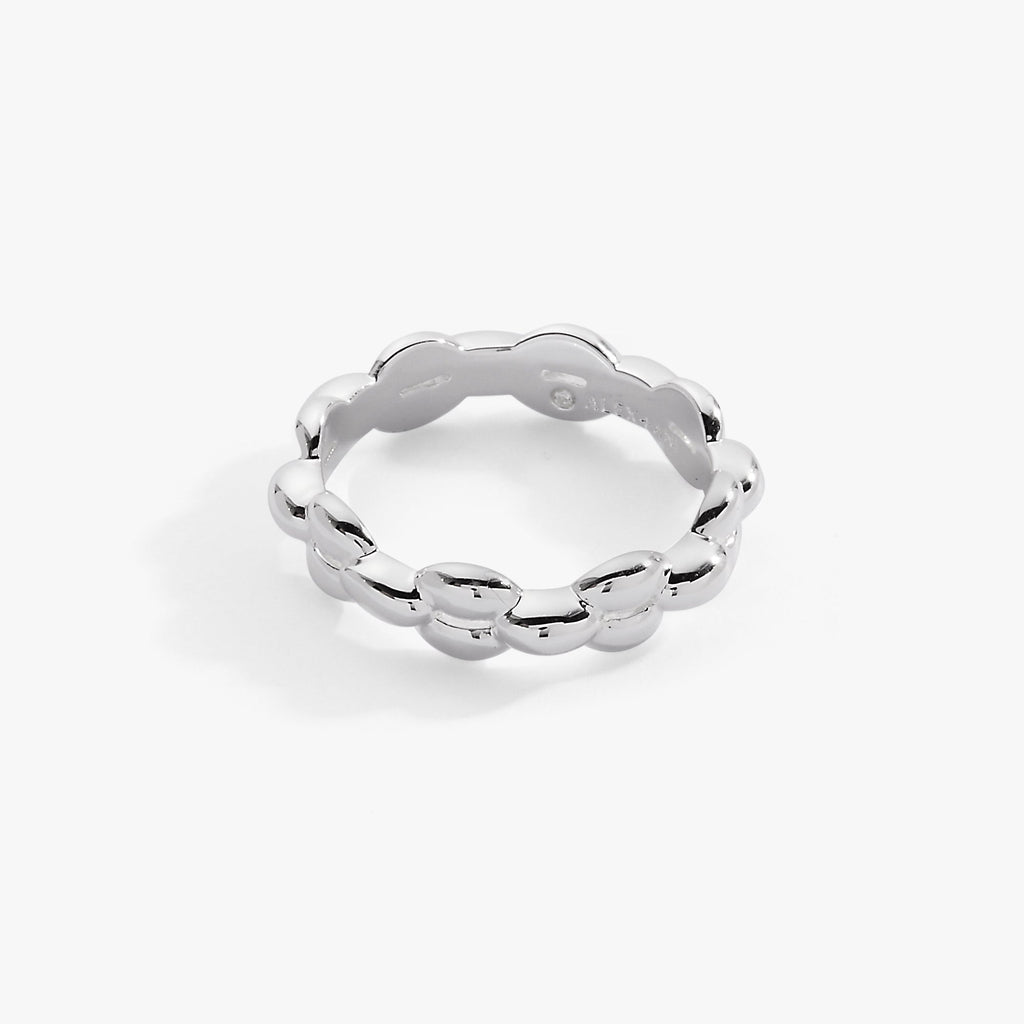 Modern puffy rope chain ring in polished silver worn on a woman's finger.