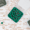 Refreshing green push pins for marking locations on a canvas wall map