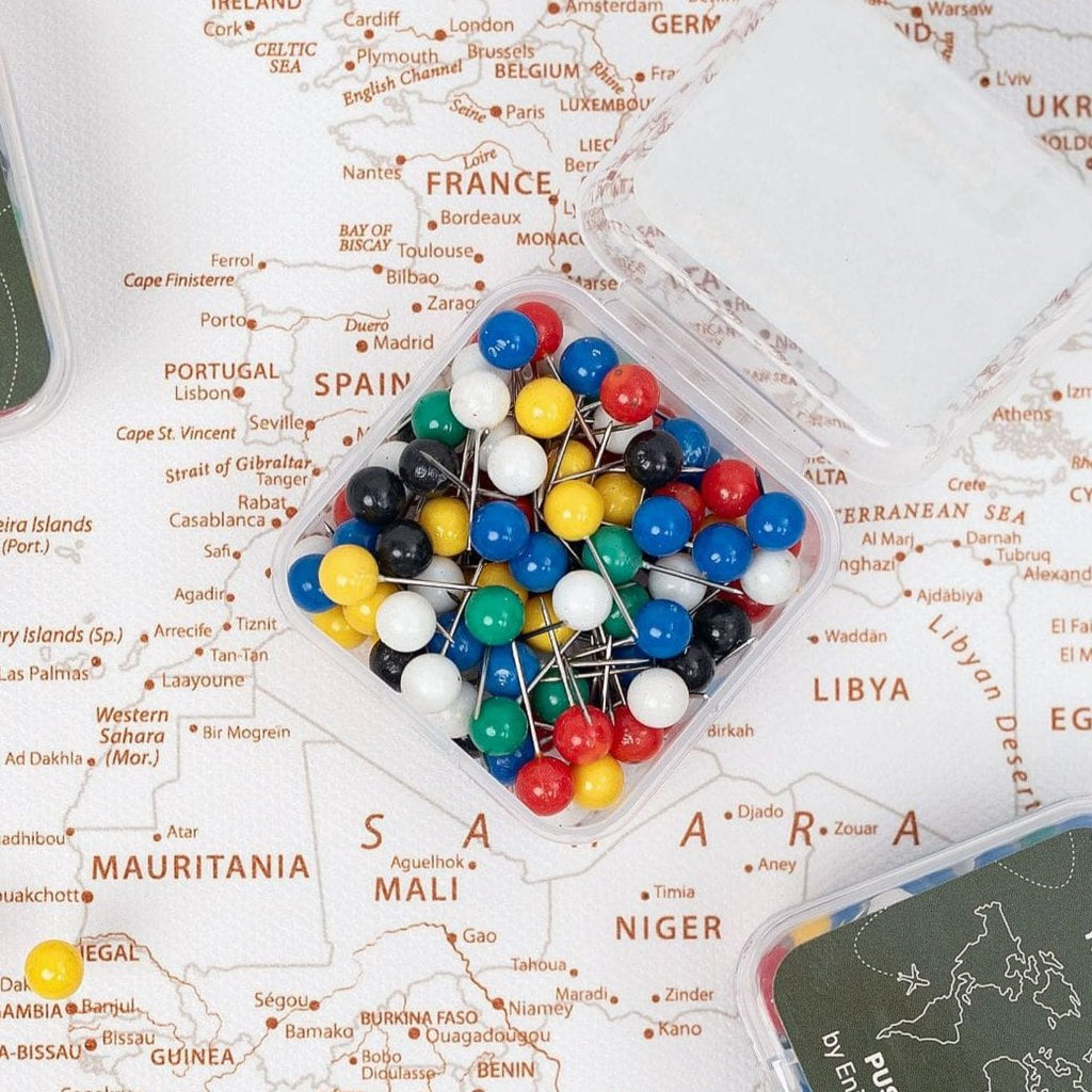 Colorful set of travel-themed push pins for wall maps and corkboards
