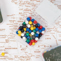 Colorful set of travel-themed push pins for wall maps and corkboards