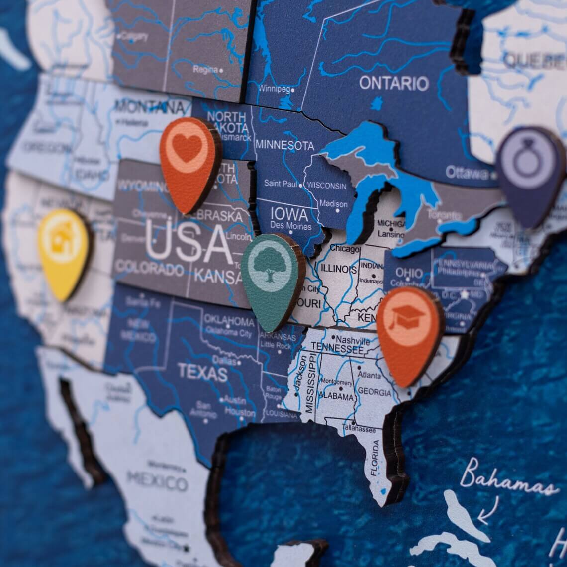 Close up of wooden location pins resting on a wooden world map surface