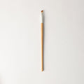 Brown and silver angled makeup brush for precise eyeliner application