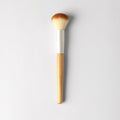 Professional vegan face brush for blending blush, bronzer, and highlighter against a clean background