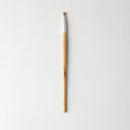 Small, vegan eyeshadow brush with beige and silver handle