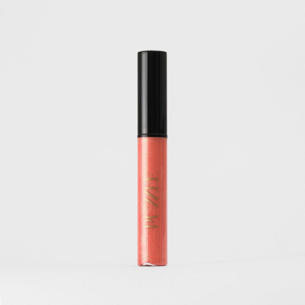 Lip gloss wand in coral and black packaging