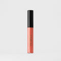 Lip gloss wand in coral and black packaging