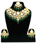 A luxurious green Kundan stone studded jewellery set with gold-plated alloy finish on a neutral background.