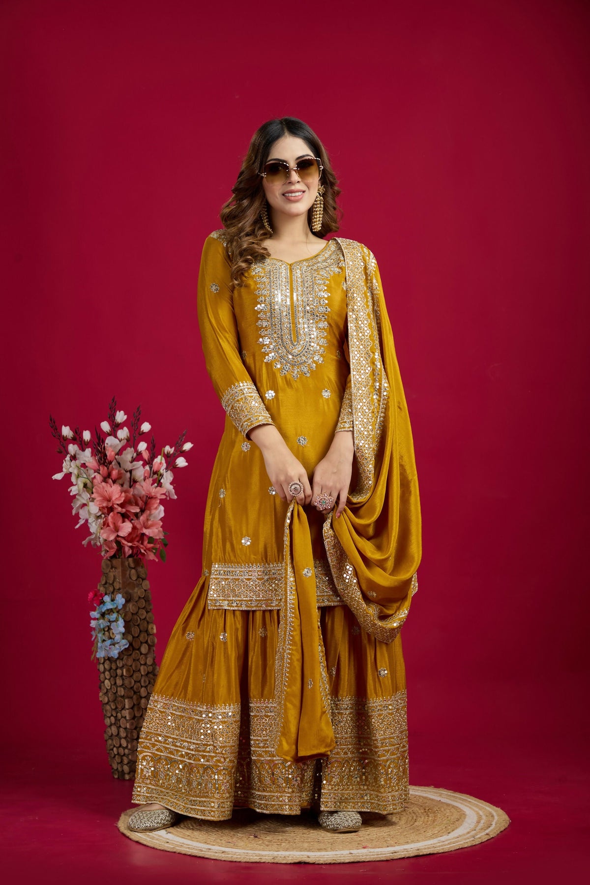Vibrant yellow silk kurta set adorned with sequins, zari, and thread embroidery for festive events.