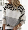 A woman wearing a cozy leopard print and color-blocked knit pullover sweater with a loose fit.