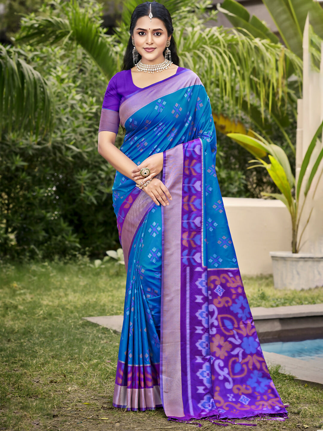 Blue Pochampalli silk saree featuring a contrasting purple blouse