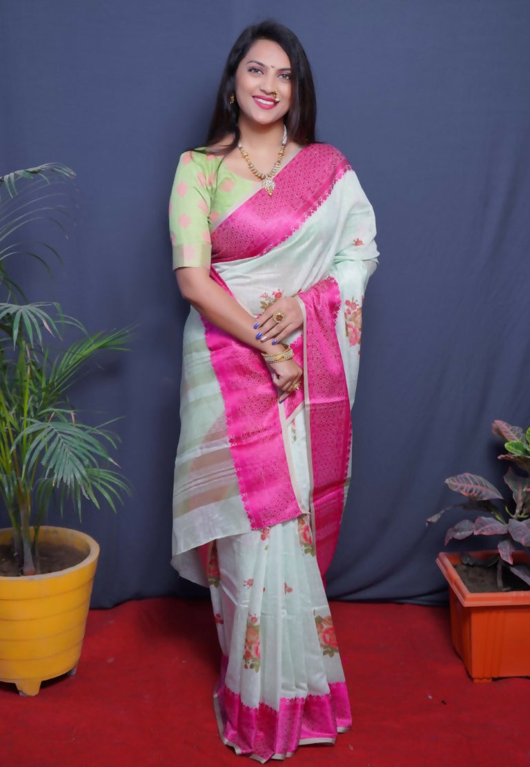 Magenta linen silk saree featuring a vibrant digital print and jacquard woven border with a green blouse.