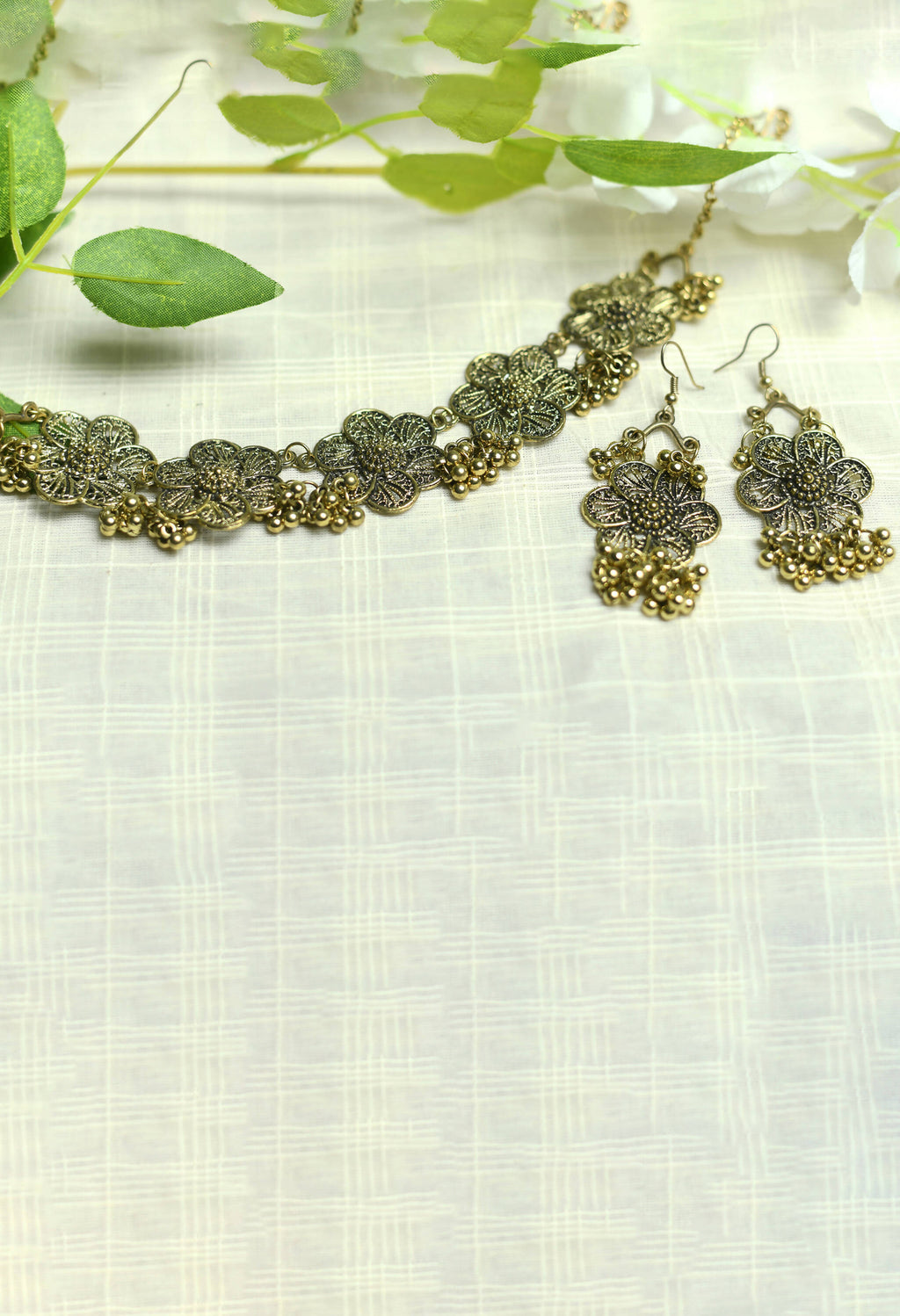 Elegant golden-plated brass choker with floral design for women.