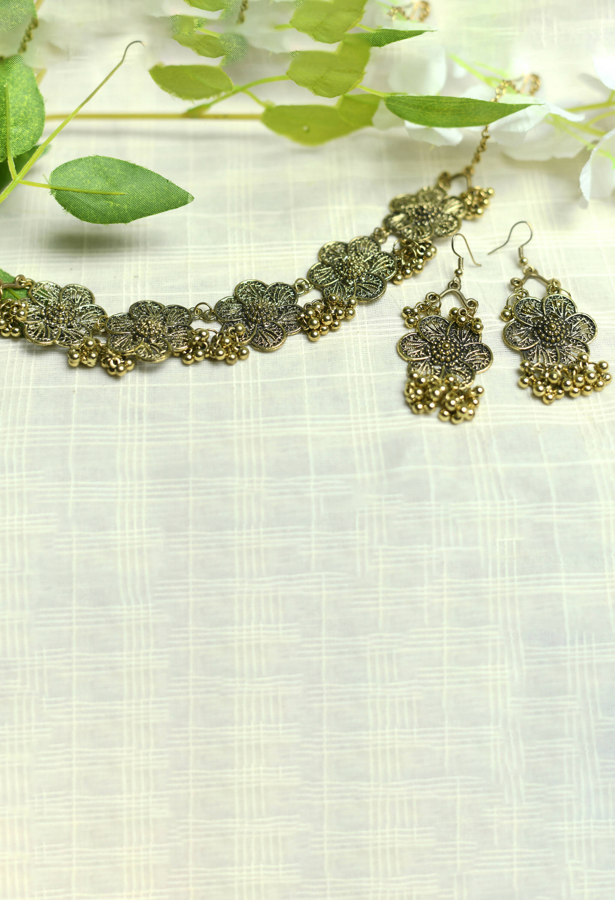 Elegant golden-plated brass choker with floral design for women.