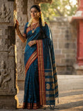 Elegant teal soft silk saree with matching blouse draped gracefully