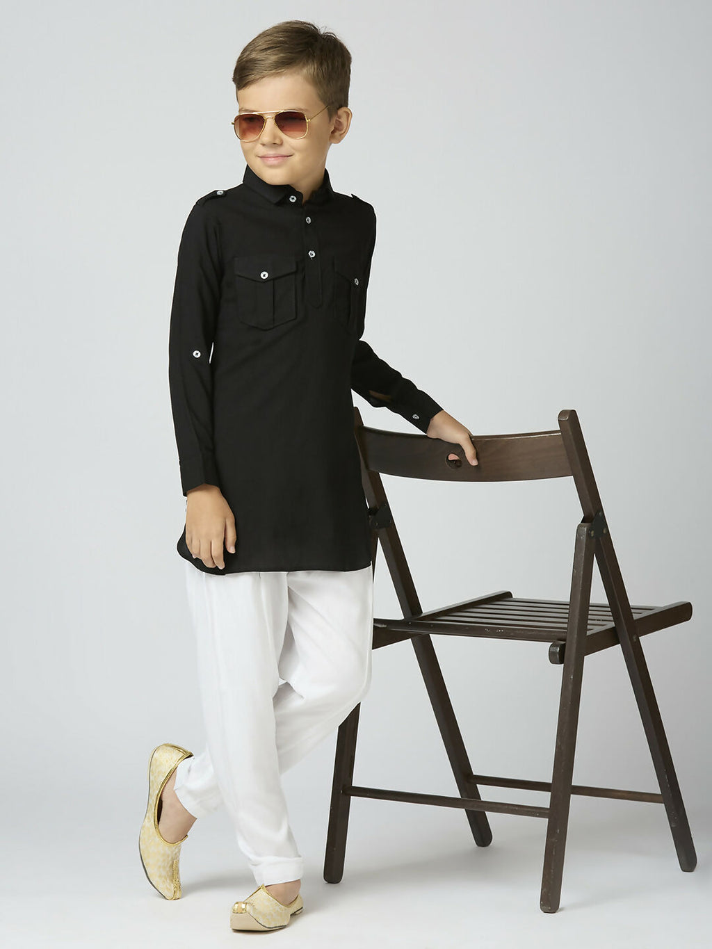 Boy wearing a classic black cotton Pathani kurta and pyjama set