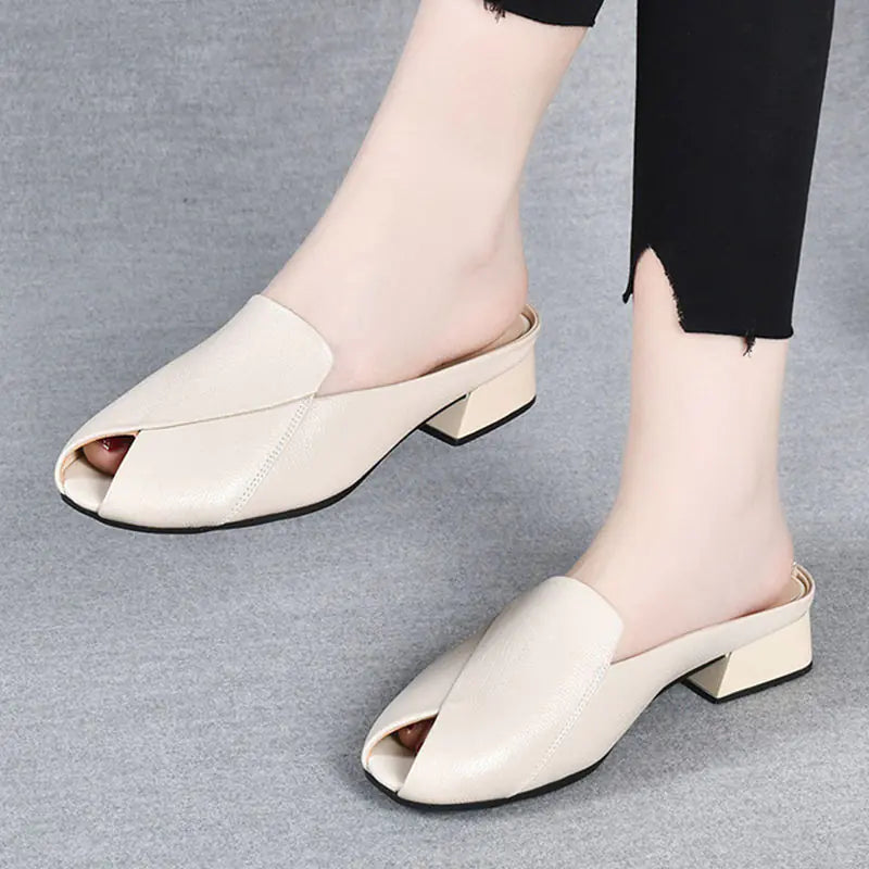Women's beige fish mouth low heel mule sandals showing open toe and slip-on style.