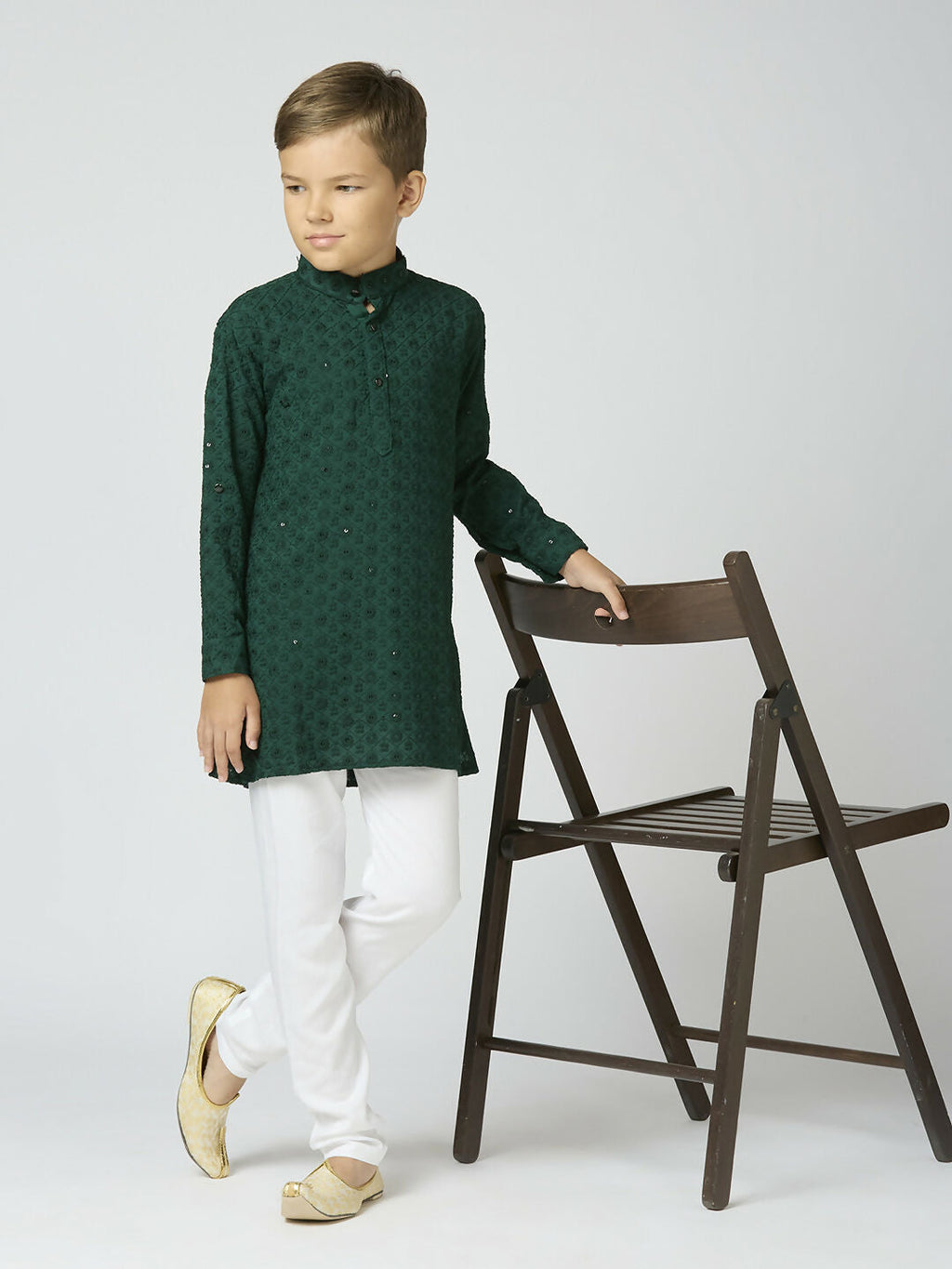 Little boy wearing a green cotton kurta set with festive sequin embellishments