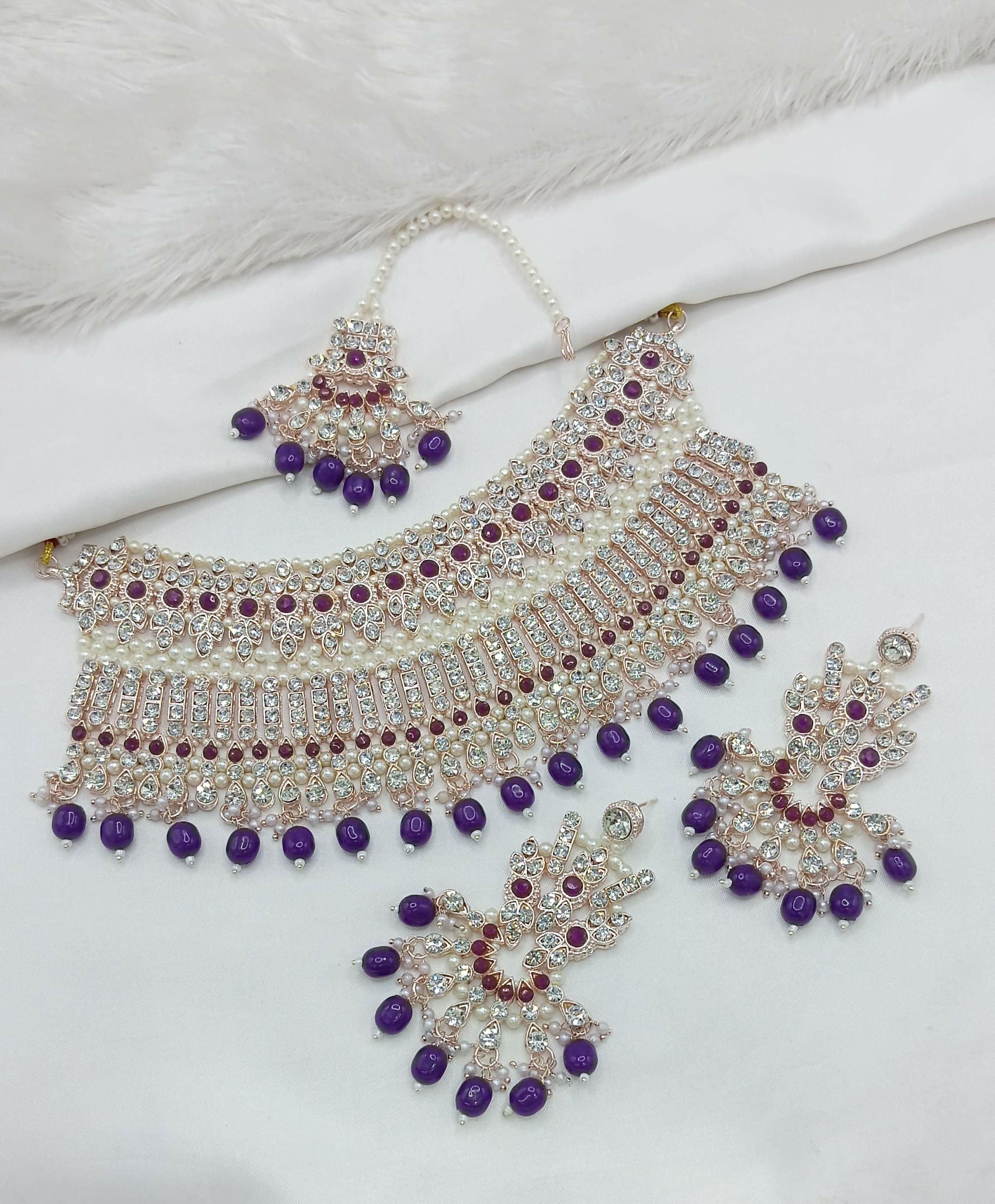 Regal purple stone work necklace set with intricate design and matching earrings