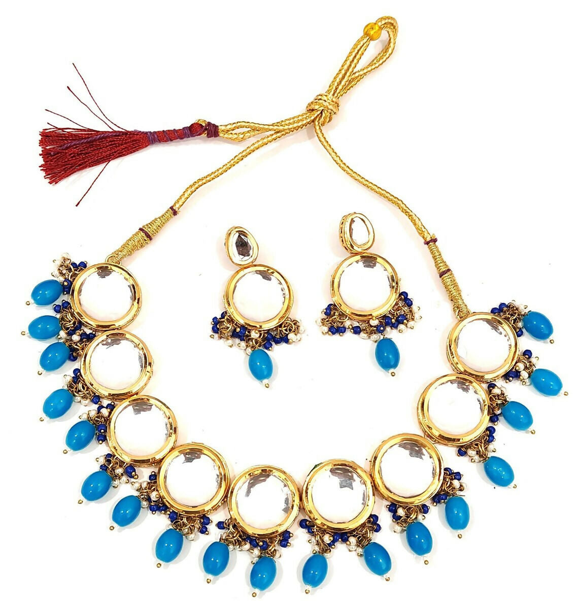 Royal gold-plated Kundan stone studded jewellery set on a velvet backdrop