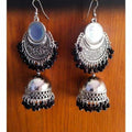 Silver oxidized Chandbali earrings with black beads and mirror tassel details.
