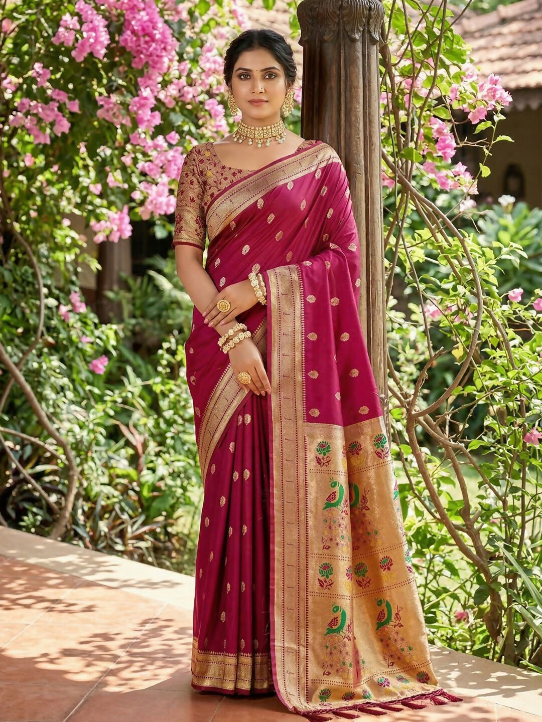 Pink soft silk saree paired with a golden silk blouse.
