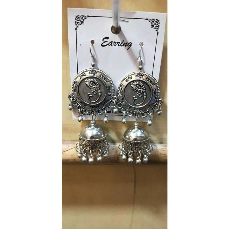 Silver Lord Ganesh jhumka earrings featuring hanging pearls and intricate traditional detailing.