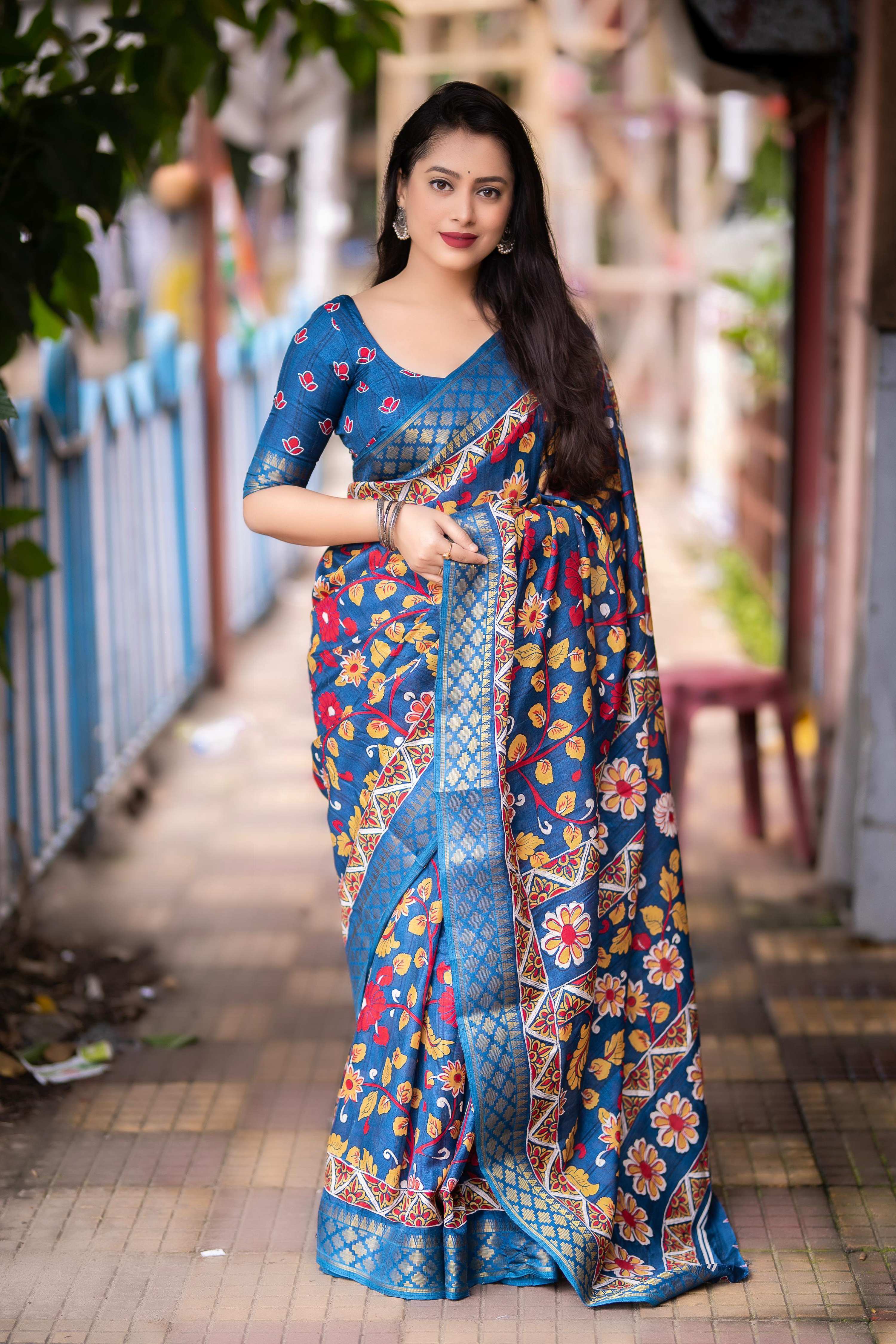Blue slub silk saree featuring Kalamkari prints and a jacquard woven zari border