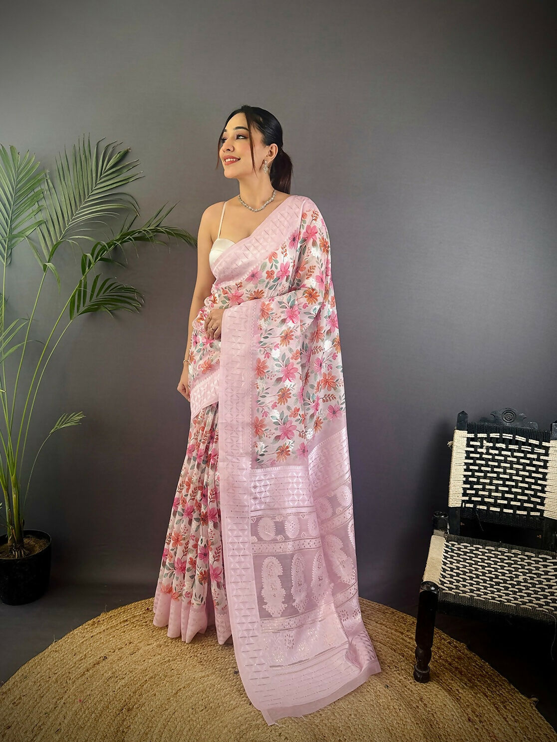 Pastel pink Banarasi silk blend saree featuring elegant floral motifs and unstitched blouse