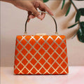 Orange Gota Patti fabric clutch bag with ornate traditional embroidery
