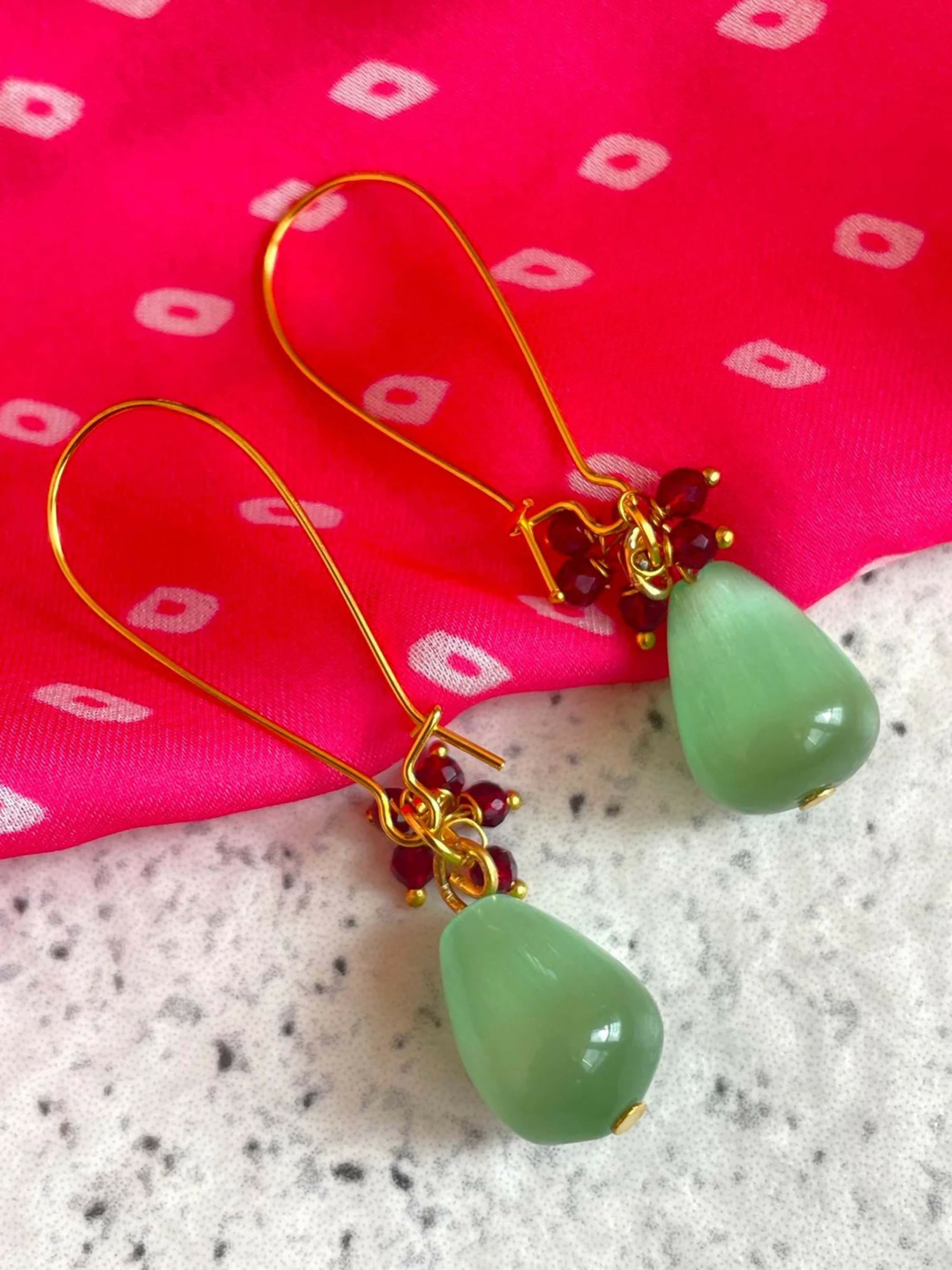 C Green Monalisa stone earrings with intricate Cheed detailing on a brass base.